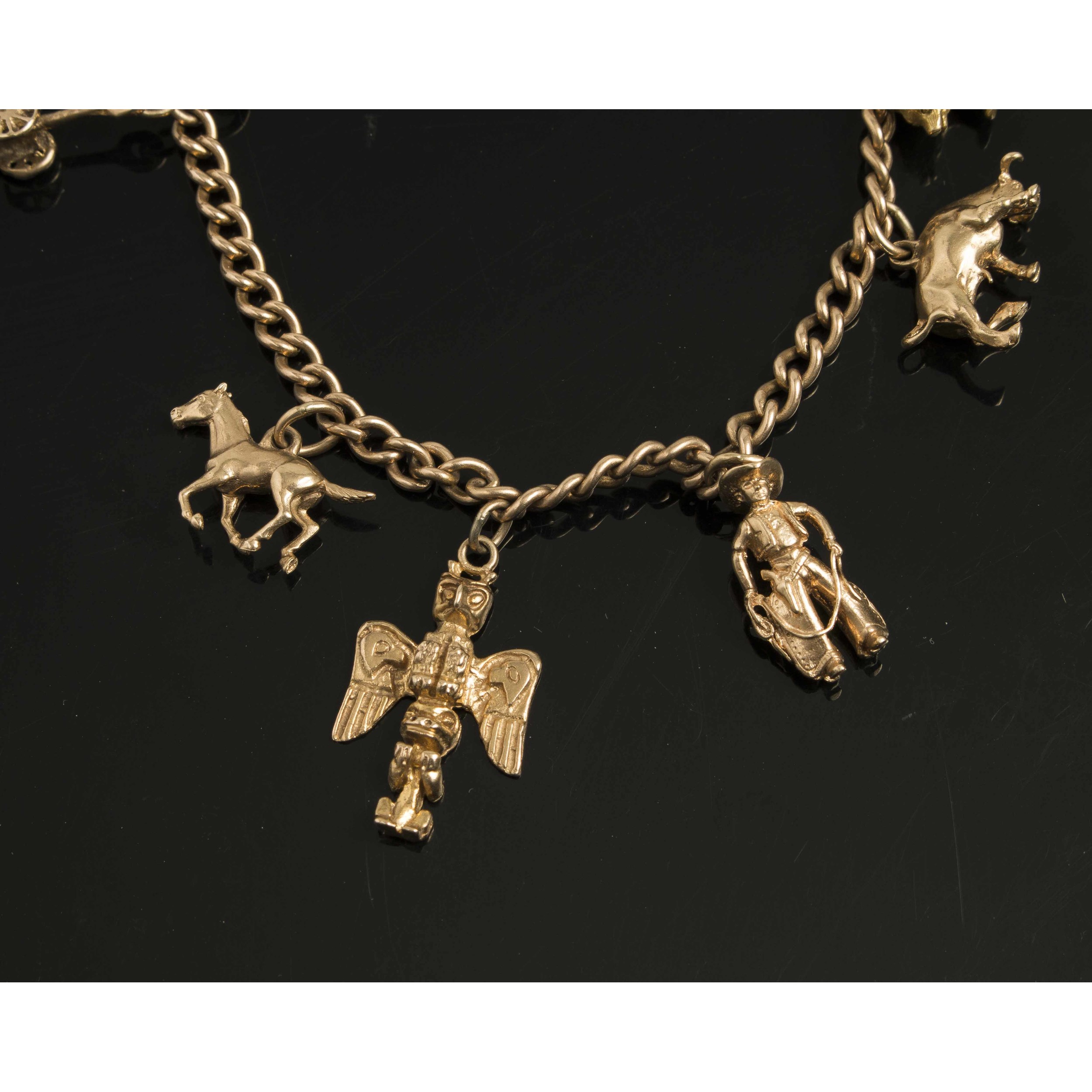 Gold Bracelet with Seven Western Themed Charms, 1014K Witherell's Auction House